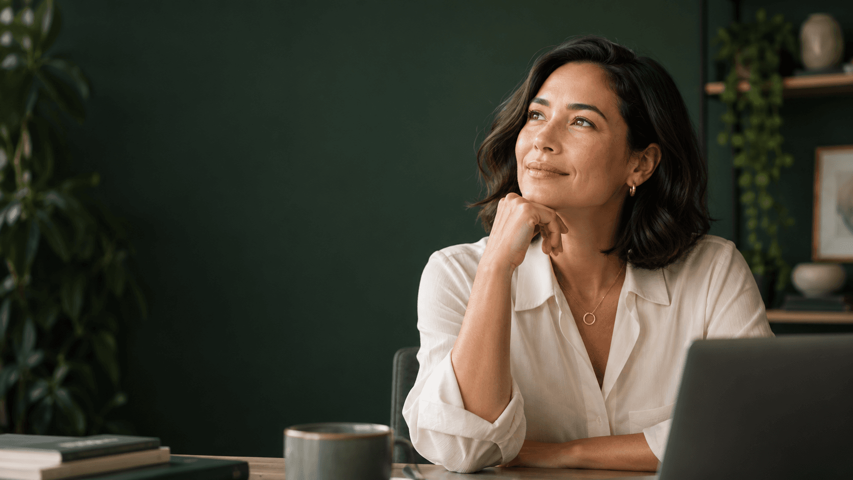 A coach reflecting at her desk